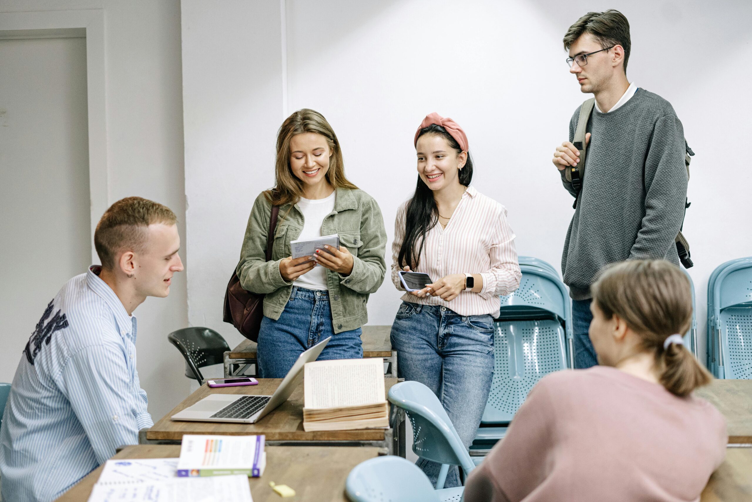 Courses A diverse group of college students engaging in a lively study session indoors.